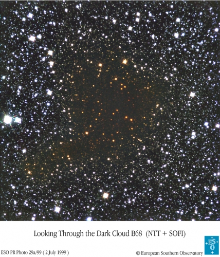 Telescopic image of Barnard 68 taken through infrared filters showing the reddening of starlight by this foreground cloud.